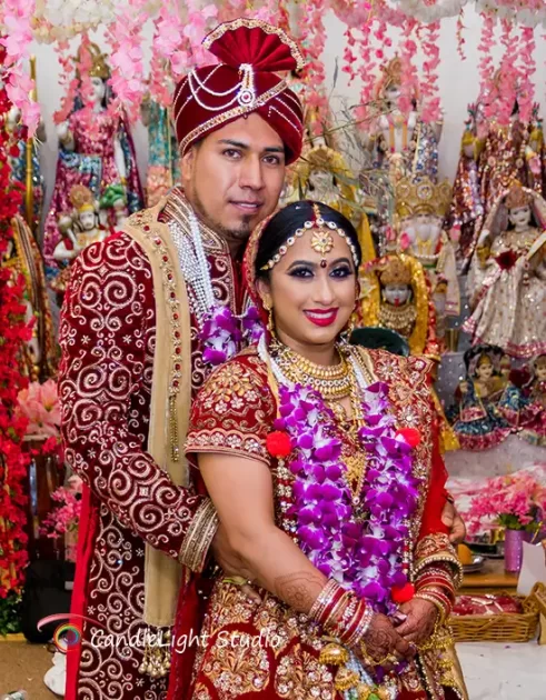 Professional Indian photographers engaged in a candid moment at a wedding event.