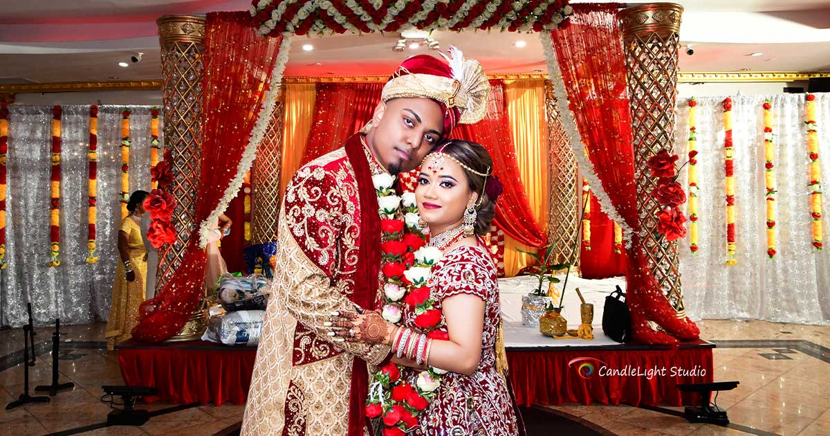 Bride and groom captured in a candid moment by professional Indian photographers.