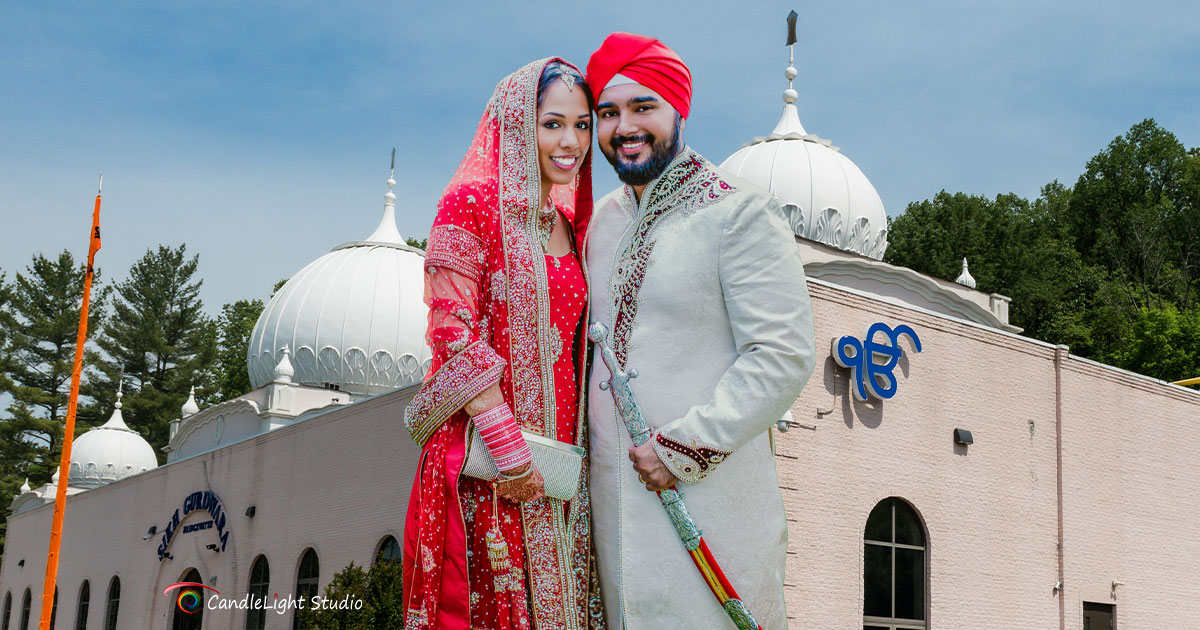A jubilant Punjabi couple in traditional wedding attire, captured by Candlelight Studio