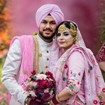Top Punjabi Wedding Photographers in New York | CandleLight Studio Punjabi family smiling during wedding ceremony in New York